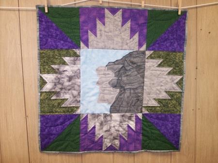 This wall hanging was sold, however my original design with machine applique center square and surrounded by delectible mountains is available
