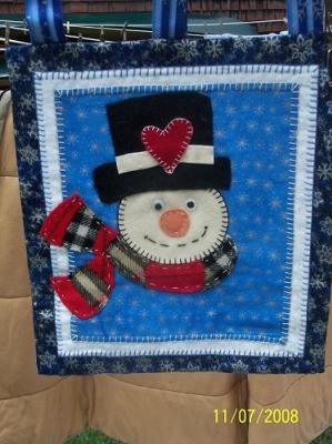 This snowman was hand appliqued using recycled wool on 100% cotton backing.