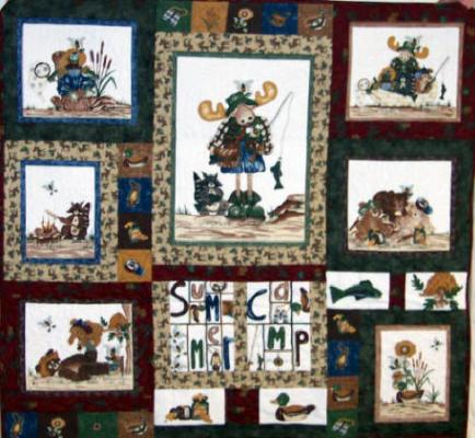Burgandy, forest green & tan outdoor prints surround whimsical moose, bear & racoon. Top & backing are constructed of quality 100% cotton, batting is thin polyester. Machine pieced and machine quilted by Linda Monasky.<br />