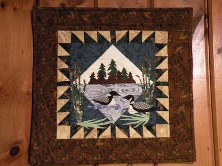 This machine applique wall hanging was designed by Debbie Field. Top & backing are constructed of quality 100% cotton, batting is thin polyester. Machine pieced, machine appliqued and machine quilted by Linda Monasky