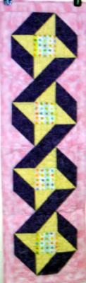 Friendship Star blocks with colorful egg print fabric in the center. This table runner was constructed using quality 100% cotton fabric. Machine pieced and machine quilted by Linda Monasky <br /><br />